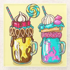 two mugs filled with different types of ice cream and candy on top of each other