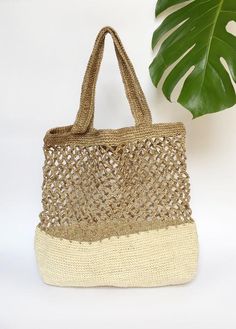 Stylish and on trend, this beautiful tote is handmade by artisans from Santander, Colombia. 100% made of Fique natural fiber, a plant similar to Agave, it is the perfect summer accessory to be used out in the city or to spend a day at the beach. With two easy to carry handles, you will want to carry it around everywhere you go!Approximate Dimensions:Height: 17" / 43 cmWidth: 16.1” / 41 cmStrap drop: 9"/ 23 cmAll of our bags are 100% handmade from natural fibers. Please allow for any color and si Beige Handwoven Vacation Bag, Handwoven Beige Bag For Vacation, Eco-friendly Woven Beige Straw Bag, Handwoven Beige Vacation Bag, Eco-friendly Rectangular Natural Shoulder Bag, White Natural Fiber Beach Bag For Travel, Natural Crochet Bag For Travel, White Bohemian Open Weave Straw Bag, Natural Handwoven Bucket Bag For Beach Season