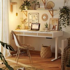 a white desk topped with a laptop computer sitting on top of a hard wood floor