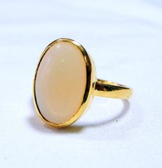 18 K solid gold and natural Opal gemstone ring. Usa ring size-7.5 ( we can adjust size), size of top-16/11 mm), weight-3.800 grams. High Luster Oval Ring In 14k Gold, High Luster 14k Gold Oval Rings, High Luster Oval Yellow Gold Rings, High Luster Yellow Gold Oval Rings, Gold Round Gemstones With Large Stone, Gold Ring With Large Oval Cabochon Stone, Gold Oval Ring With Large Stone, Formal Opal Open Ring, Elegant Yellow Gold Moonstone Ring With Large Stone