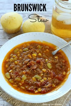 a white bowl filled with stew next to some bread