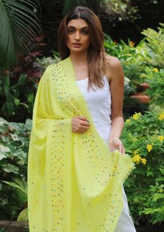 Infuse your look with a vibrant burst of color by styling yourself with this yellow linen and modal blended scarf. Its lightweight and breathable fabric makes it an ideal and easy-to-wear accessory. The scarf is adorned with fun and quirky multi-colored rudraksha pearls, delicately scattered across and as an inner border, adding a playful and whimsical touch to your outfit. Stand out from the crowd and embrace your individuality with this enchanting scarf that effortlessly combines comfort, styl Burst Of Color, Multi Colored, Neck Tie, Breathable Fabric, Cashmere, Unique Designs, Yellow, Fabric, How To Wear