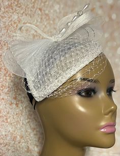 White Teardrop  Sinamay Fascinator Hat accented with veil netting, pearls, hat pin and rhinestones. The hat pin may vary. Perfect for church, weddings, funerals and special occasions. Hat measures approximately 6x8 inches. The hat affixes to the head by a hat elastic. Love what you see, but would like it in a different color, shape or size? Please contact us by sending a message. We offer custom hats in a variety of styles. PLEASE NOTE All items for Free Shipping will be shipped via USPS First C Tulle Hat For Weddings And Kentucky Derby, Elegant Tulle Fascinator For Kentucky Derby, Elegant Tulle Fascinator, Elegant Tulle Mini Hats For Evening, Elegant Tulle Mini Hats For Wedding, Elegant Mini Hats For Evening, Elegant Evening Bridal Accessories In Tulle, Adjustable Tulle Fascinator For Wedding, Adjustable Tulle Wedding Fascinator