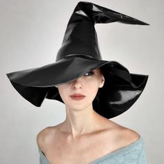 a woman wearing a black witches hat