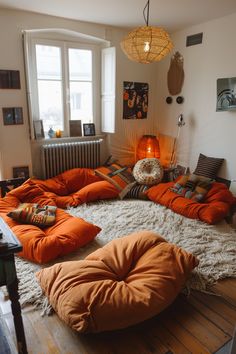 an orange bean bag chair sitting on top of a wooden floor next to a window