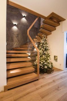 there is a christmas tree next to the stairs