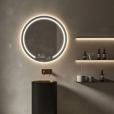 a round mirror on the wall above a sink in a bathroom with shelving and shelves