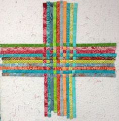 a cross made out of strips of fabric