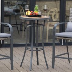 two chairs and a table with fruit on it