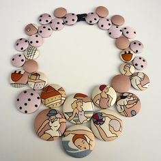 a bunch of buttons that are on top of a necklace with some people in it