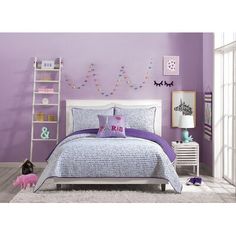 a bedroom with purple walls and white furniture