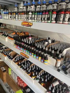 the shelves are filled with different types of paint