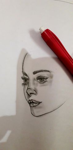 a drawing of a woman's face with a red pen on top of it