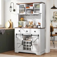 a kitchen with white cabinets and shelves filled with food, drinks and utensils