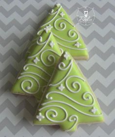 two green christmas tree cookies sitting on top of each other