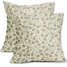 two pillows with green leaves on them