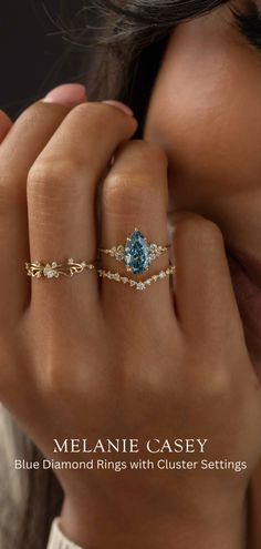 a woman's hand with a ring on her finger and the cover of melanie casey's blue diamond rings with cluster settings