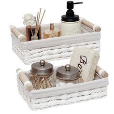 two wicker baskets with soap, lotion and other items in them on a white background