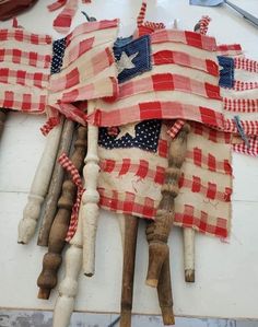 an american flag made out of old wooden dowels and some other items on a table