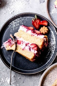 a piece of cake on a plate with strawberries and almonds next to it