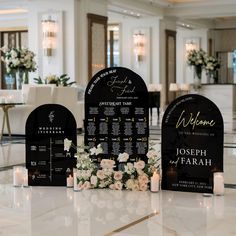 wedding seating plan displayed on marble table with candles and flowers in centerpieces at reception