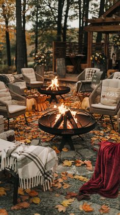 a fire pit surrounded by chairs and blankets