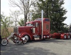 a red semi truck parked in a parking lot