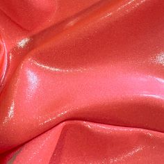 a close up view of a shiny red material that looks like it has been dyed