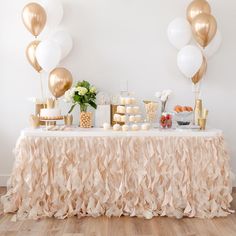 a table topped with lots of desserts and balloons