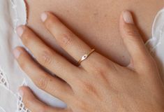 a close up of a person's hand with a ring on it