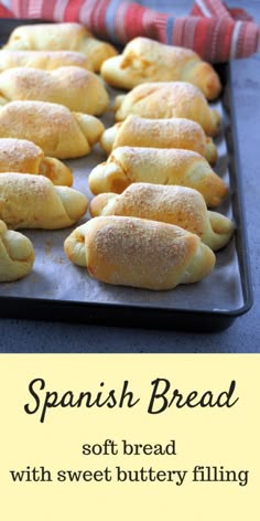 some bread is sitting on a baking sheet with the words spanish bread in front of it