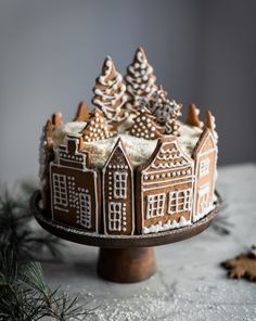 a cake decorated with gingerbread houses and trees