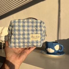 Our Azure Mini Makeup Bag is a stylish and compact carry-all designed to hold your essentials with a classic look.    The quilted exterior is made from a beautiful blue gingham material, complemented by a matching gingham interior.     Ideal for organizing your makeup and beauty essentials or serving as a travel organizer (especially when you need something more compact than our large bags), this is a must-have for anyone who values both organization and style.   Size: 6" x 4" x 5" Everyday Quilted Pouch Cosmetic Bag, Blue Quilted Bag For On-the-go, Blue Rectangular Picnic Bags, Daily Use Blue Quilted Bags, Daily Use Gingham Bags With Zipper Pouch, Blue Quilted Bags For Daily Use, Gingham Bags With Zipper Pouch For Daily Use, Gingham Pouch Bag For Daily Use, Gingham Interior