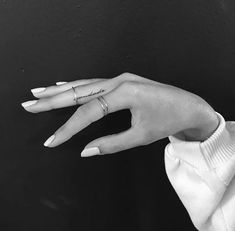 a woman's hand with a ring on it and the word love written on her finger