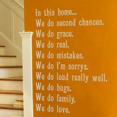 a wall that has some writing on it in front of a stair case and yellow walls