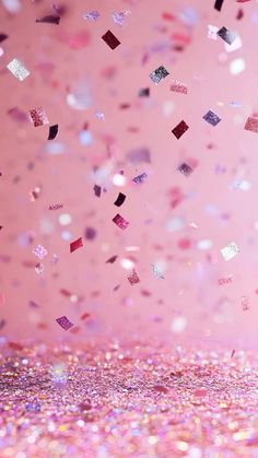 a pink background with lots of confetti