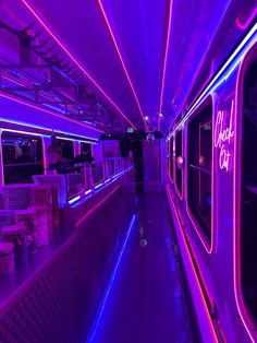 the inside of a bus with neon lights on it's walls and flooring