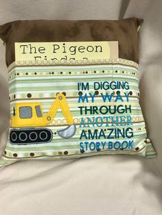 the pillow is made to look like it has a construction truck on it and reads, i'm digging through another amazing story book