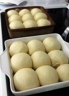 two pans filled with dough sitting on top of a stove