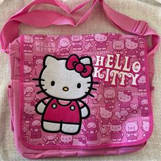 a pink hello kitty bag with an image of the hello kitty on it's side