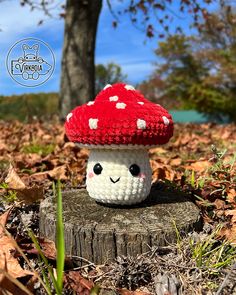 a crocheted mushroom sitting on top of a tree stump