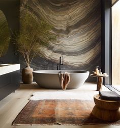 a bathroom with a large bathtub next to a window