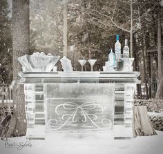 an ice sculpture in the middle of a snowy forest