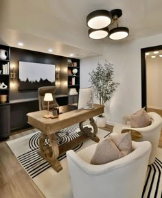 a living room with two white chairs and a wooden table in the middle of it