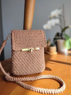 a crocheted purse sitting on top of a wooden table