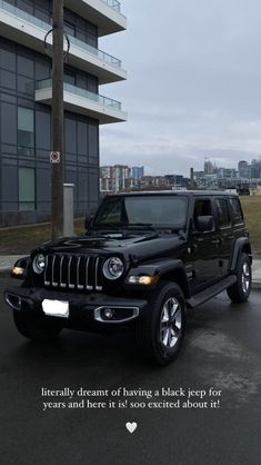 a black jeep parked in front of a building