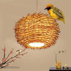 a bird sitting on top of a wooden light fixture next to a tree branch with red berries