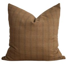 a brown pillow with a tan and black checkered pattern on the front, sitting on a white background