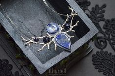 "HOLIDAY SHIPPING NOTICE: Kindly refer to the store policies for delivery estimates for your location: https://www.etsy.com/shop/ithuriell#policies Elaborate elven necklace than combines blue vibrancy of lapis lazuli with thunderstorm-blue of sodalite. Complemented with dark blue goldstone glass reminding of starry night sky. The very embodiment of \"something blue\", and a perfect adornment for those in love with ever-changing heavens. Lapis lazuli, sodalite, goldstone glass, polymerclay, Zinc- Mystical Blue Pendant Necklace, Handmade Mystical Blue Jewelry, Mystical Blue Pendant Jewelry, Blue Mystical Pendant Jewelry, Mystical Handmade Blue Necklaces, Mystical Handmade Blue Necklace, Handmade Mystical Blue Necklace, Unique Lapis Lazuli Pendant Necklace, Unique Lapis Lazuli Gemstone Necklace