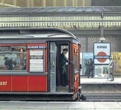 a red trolley car sitting on top of a train track